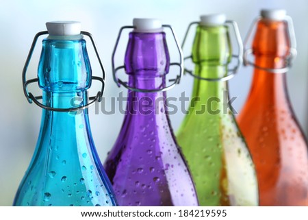 Colorful bottles on light background
