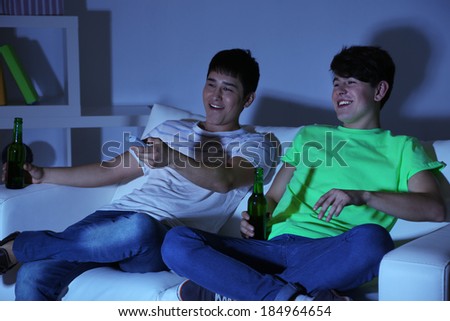 Two friends watching football at home of blacking-out