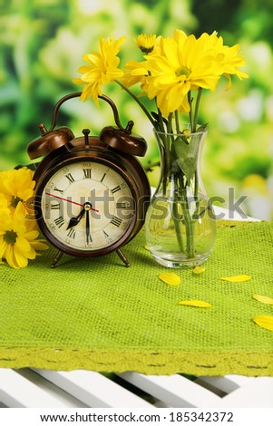Digital alarm clock on table, on nature background