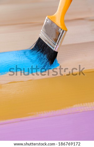 Brush painting wooden furniture, close up