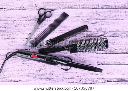 Professional hairdresser tools on color wooden background