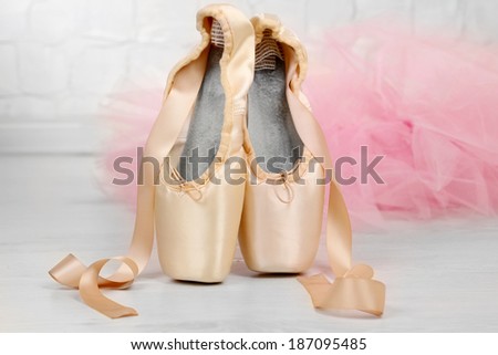 Ballet pointe shoes on floor in dance hall