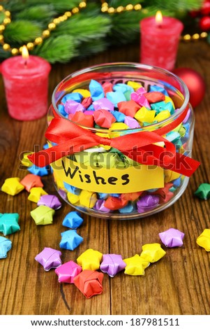 Paper stars with dreams in jar on table close-up