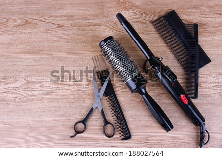 Professional hairdresser tools on wooden background