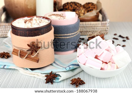 Mug of hot drink decorated in felt on wooden table