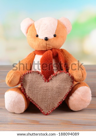 Bear toy on table on light background