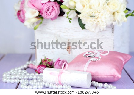 Beautiful wedding composition with flowers on table on fabric background