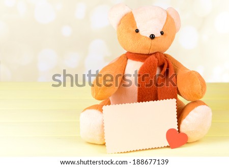 Bear toy on table on light background