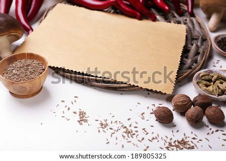Different spices and blank paper, isolated on white
