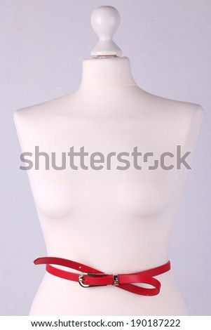 Strap on mannequin on grey background close-up