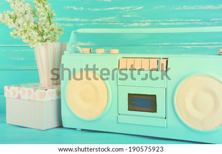 Still life with colorful retro radio, on blue wooden background