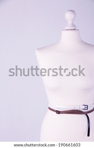 Straps on mannequin on grey background close-up