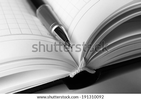 Pen on opened book, close up