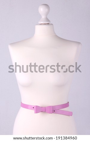 Strap on mannequin on grey background close-up