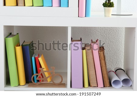 Books on white shelves close-up