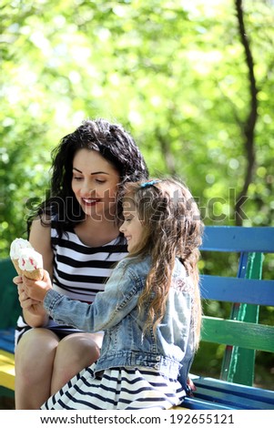 Happy mom and daughter. Walk in the green park