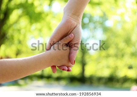 Mom and daughter hands, outdoors
