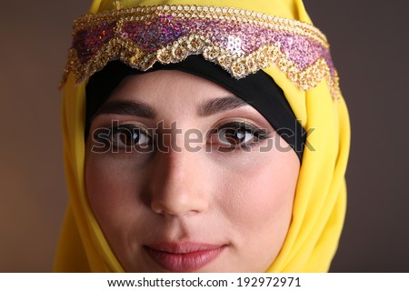 Beautiful muslim arabic woman on dark color background
