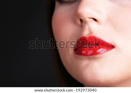 Girl with red lips on dark background