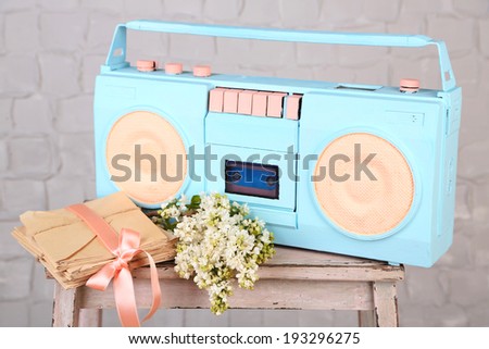 Still life with colorful retro radio, on grey wall wooden background