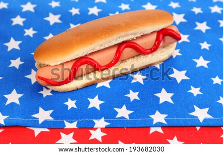 Tasty hot dog on napkin with stars