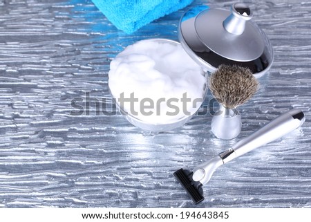 Male luxury shaving kit with towel on gray background
