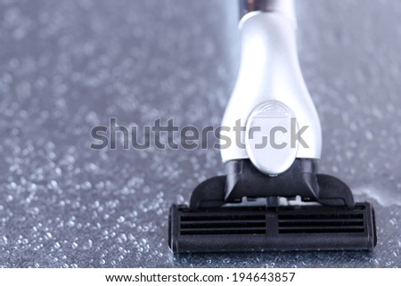 Shaving razor on gray background