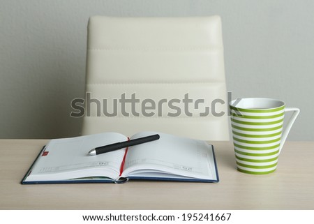 Empty workplace in office on gray background
