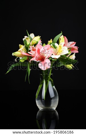 Alstroemeria flowers in vase on table on dark grey background