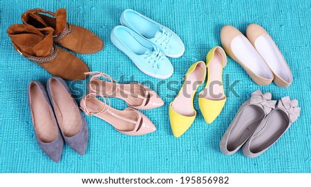 Female fashion shoes on blue carpet