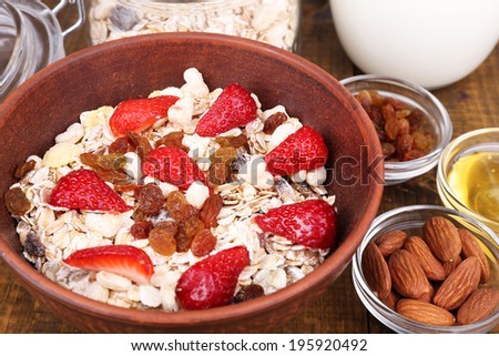 Healthy cereal with milk and strawberry on wooden table