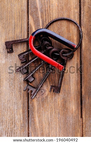 Magnet with old keys on wooden background