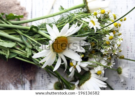Beautiful bouquet of daisies on wooden background