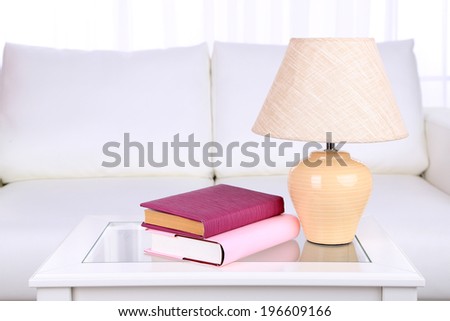 Books and lamp on coffee table in room