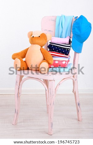 Clothes on chair on gray wall background