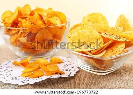 Homemade potato chips in glass bowls on table