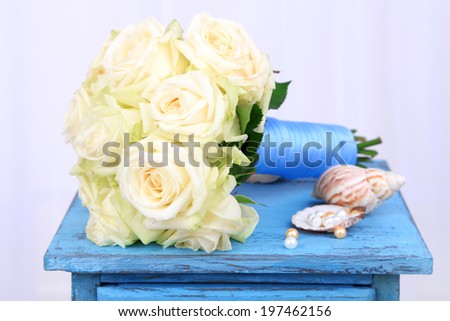 Beautiful wedding bouquet with roses on old table