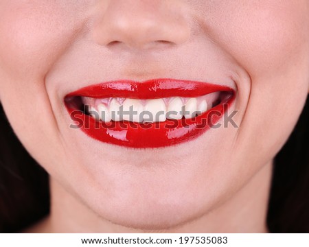 Smiling woman with red lips close-up