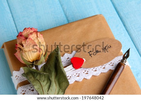 Natural style handcrafted gift box on color wooden background. Concept of natural style design
