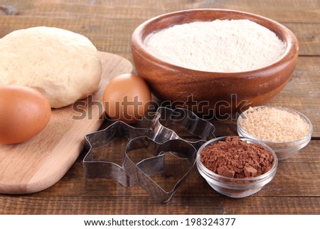 Ingredients for making cookies on wooden background