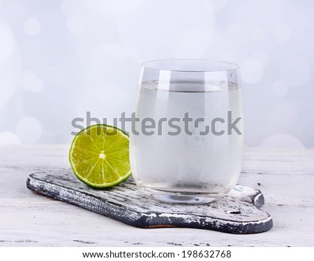 Cool water in glass, on light background