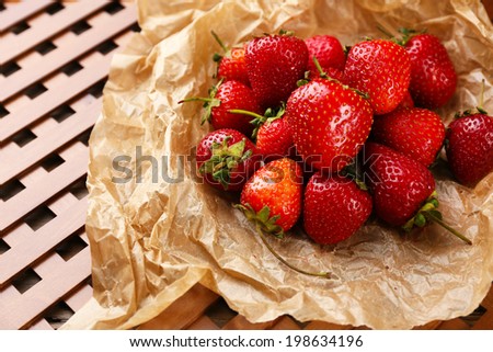Red ripe strawberries with chocolate on brown paper