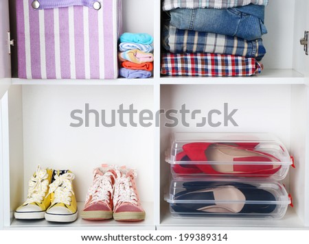 Clothes and shoes on shelves close-up