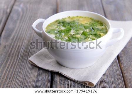 Delicious green soup with sorrel on table close-up