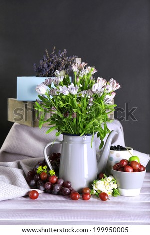 Still life with flowers and fruits on dark background