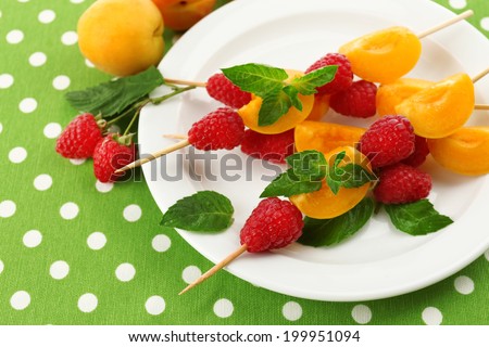 Fresh fruit kebabs for healthy snack on plate close up