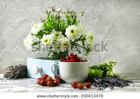 Still life with flowers and fruits on table