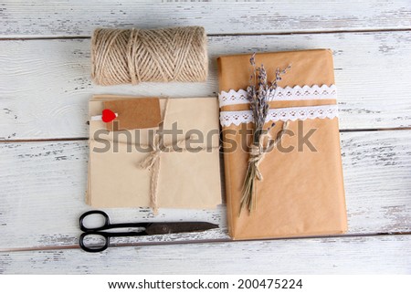 Natural style handcrafted gift box on wooden background. Concept of natural style design