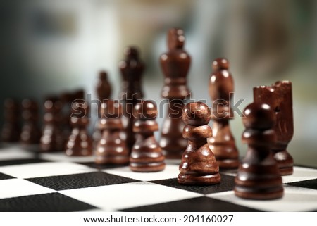 Chess board with chess pieces on dark background