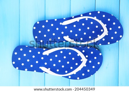 Color flip-flops on wooden background